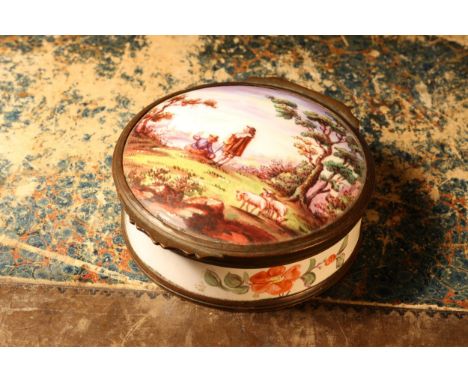 A 19th century enamel circular table snuff box, hinged cover painted with young shepherds in a pastoral idyl, the side and ba