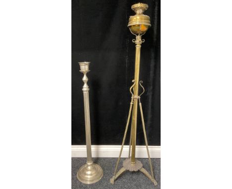 A brass lamp stand with Duplex burners and a tripod base, each terminating with a mask; a steel candle stand with fluted colu