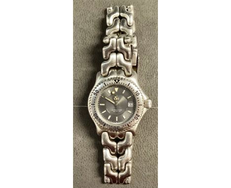 A lady's Tag Heur stainless steel watch, steel grey engine turned dial, baton indicators, centre seconds, date aperture, wate