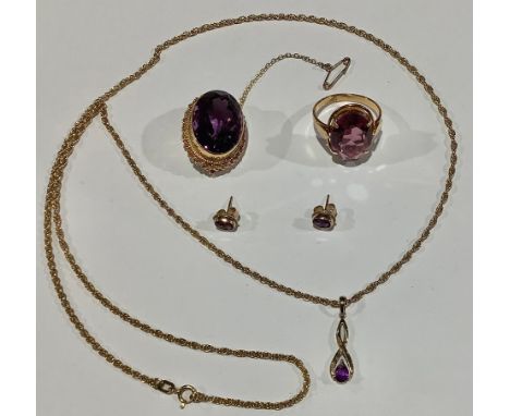 A composed suite of 9ct gold and amethyst jewellery, comprising faceted oval brooch, pin clasp with safety chain, 3cm wide, m