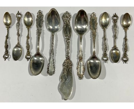 A set of six continental silver teaspoons, the hafts as semi-nude mermaids, open terminals, marked KW 800; a set of four cont