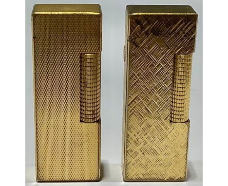 A gold plated Dunhill cigarette lighter; another (2) 