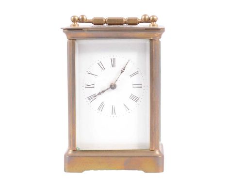 Brass carriage clock, white enamel dial, Roman numerals, with key, 11cm.
