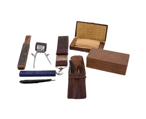 Collection of barber equipment including cut-throat razors, Weltbekannt scissors, Brown and Sharp manual clippers, leather sh