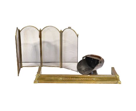 Pair of brass candlesticks, a brass fender, 124cm wide, 35cm deep, scuttle, and fire guard