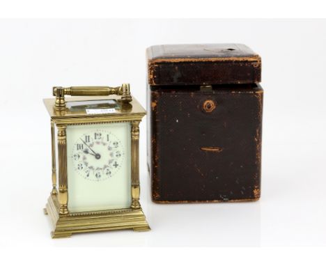 Early 20th century brass carriage clock with maroon leather case. 13cm.   