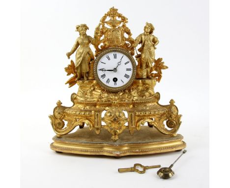 French late 19th century  gilt-metal mantle clock, surmounted by figures, with white metal dial, 29 cm high, on base, with ke