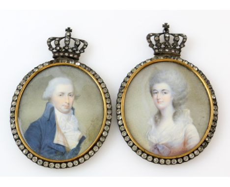 Pair of early 19th century portrait miniatures of a lady and a gentleman in white metal and paste mounts with crown finials, 