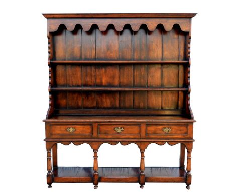 18th century oak dresser with plate racks above a base pot shelf, three drawers, on turned legs, 189cm x 163cm..   