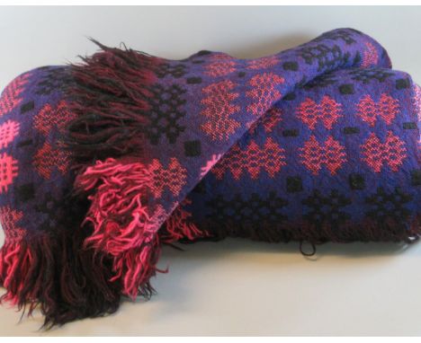 Two vintage woollen blankets; one a purple ground Welsh tapestry fringed edge blanket, the other a blue and cream fringed edg