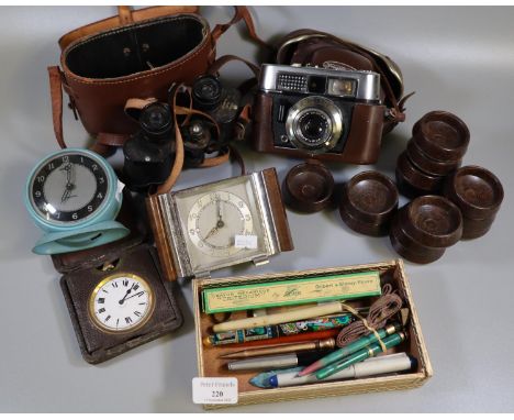 Box of oddments to include; 8 day Swiss made travelling alarm clock in leather case, vintage Voigtlander camera, pair of Kinu