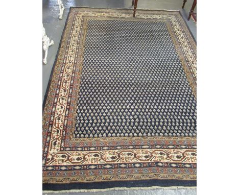 Middle Eastern design navy ground carpet. Overall with floral and geometric decoration 294x196cm approx. (B.P. 21% + VAT) 