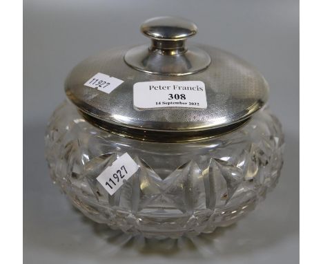 Heavy deeply cut crystal glass baluster shaped lidded bowl, the cover in engine turned silver with London hallmarks. Silver w