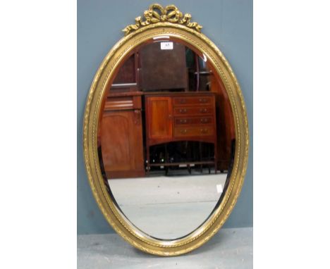 19th century gilt framed oval mirror with ribbon finial 80cm by 56cm Provenance: Part of a collection of high quality reprodu