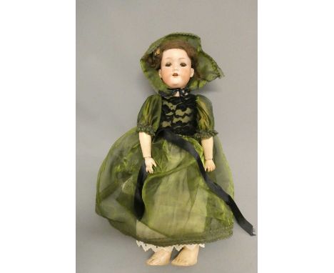 An Armand Marseille bisque socket head doll, with brown glass sleeping eyes, open mouth, teeth, wood and composition jointed 