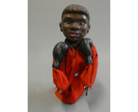 Boxer puppet with boxing action arms with a look of a very young Mohammed Ali. Some wear and holes in his clothing, good work