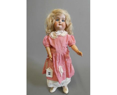 An Ernst Metzler bisque socket head doll, with blue glass sleeping eyes, open mouth, teeth, blond wig, wood and composition j