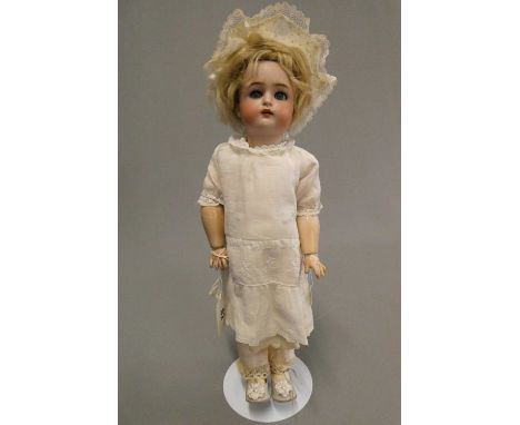 A Kammer &amp; Reinhardt Halbig bisque socket head doll, with blue glass sleeping eyes, open mouth, applied teeth, pierced ea
