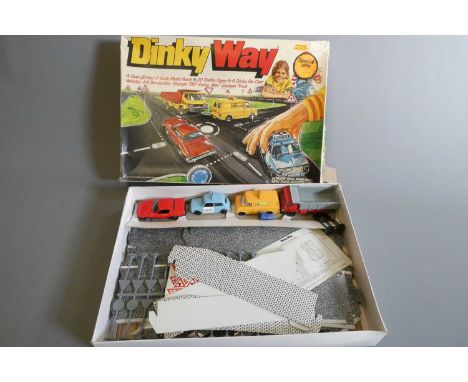  Dinky Way Road Set with four vehicles and card road way pieces, box and packing poor, model and track good (Est. plus 24% bu