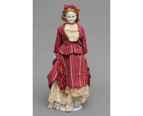 A Victorian china shoulder head doll, with painted face, blond wig, fabric body, china lower limbs and moulded shoes, 15 3/4"