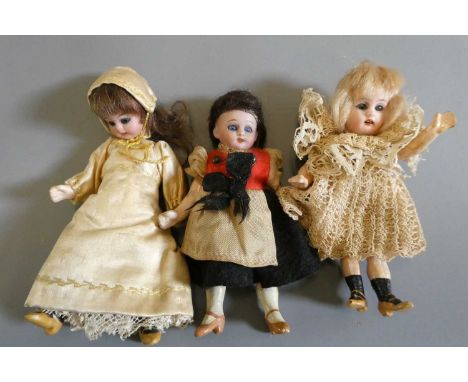 Three bisque socket head doll's house dolls, all with blue glass sleeping eyes, open mouths, teeth, wigs, composition jointed