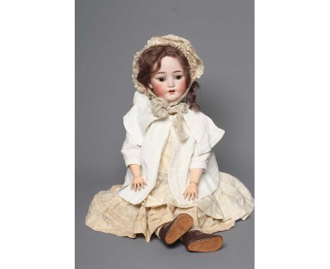 An S &amp; C bisque socket head doll, with brown glass sleeping eyes, open mouth, applied teeth, pierced ears, wood and compo