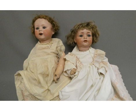 Two German bisque socket head dolls, comprising a 19 1/2" Simon &amp; Halbig 121 50 with blue glass sleeping eyes, open mouth