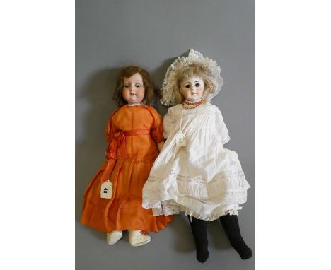 A Max Oscar Arnold bisque socket head doll with blue glass sleeping eyes, open mouth, teeth, brown wig, wood and composition 