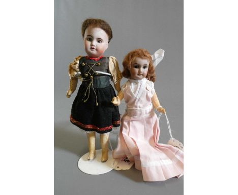 Two small SFBJ bisque socket head dolls, both with composition bodies and straight legs, one 8 1/4" long with brown glass fix