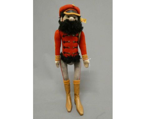 A Steiff Hungarian cavalry man, in red tunic with hat and beard, with ear button and label, 17 1/2" tall (Est. plus 24% buyer