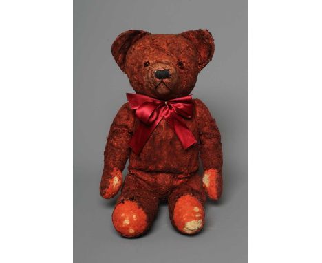A pre-war red art silk teddy bear, possibly Chad Valley, with sewn nose, red glass eyes and felt pads, 15 1/2" long (Est. plu