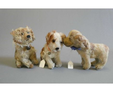Three vintage plush dogs, including one with a Steiff button to its ear, others possibly by the same maker (Est. plus 24% buy