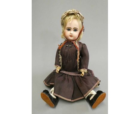 A Tete Jumeau bisque socket head doll with blue glass fixed eyes, closed mouth, pierced ears, blond wig, wood and composition