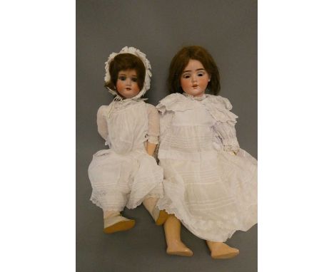 Two Schoenau &amp; Hoffmeister bisque socket head dolls, comprising a 24 1/2" 1909 5 3/4 and a 25 1/2" 800 8, both with brown
