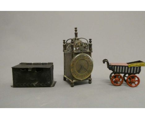 Three doll's house items, comprising a 3 3/4" British made brass lantern clock, a 2 3/8" tinplate penny toy doll's pram and a