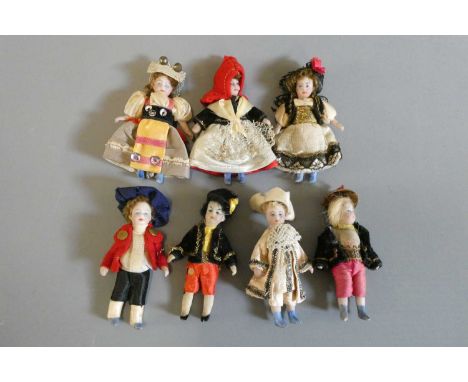 Seven all bisque doll's house dolls, all with painted features and shoes, straight legs and original outfits, all approx. 2 1