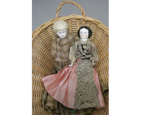 Two antique china shoulder head dolls, with moulded hair, painted features, fabric bodies, bisque lower limbs and fabric bodi
