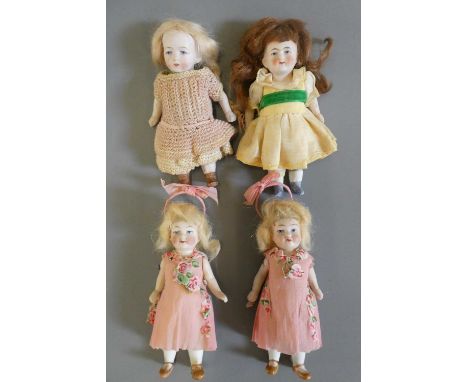 Four all bisque doll's house dolls all with jointed shoulders and hips, straight legs, wigs, painted features and painted and