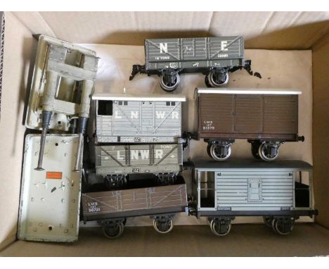 Six Bassett-Lowke tinplate goods trucks including coal wagons and brake vans and two hydraulic buffer stops, good+ (Est. plus