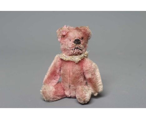 A rare Schuco pink teddy bear compact, with neck ruff and powder puff, 3 3/4" long (Est. plus 24% buyer's premium inc. VAT)Co