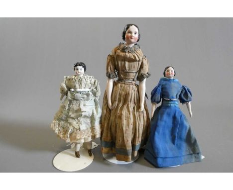 Three Victorian china shoulder head dolls, all with moulded and painted features, comprising one 10 3/4" and one 7" doll with