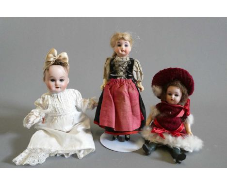 Three small bisque socket head dolls, all with composition bodies, one 6" Kammer &amp; Reinhardt 15 doll with blue glass fixe