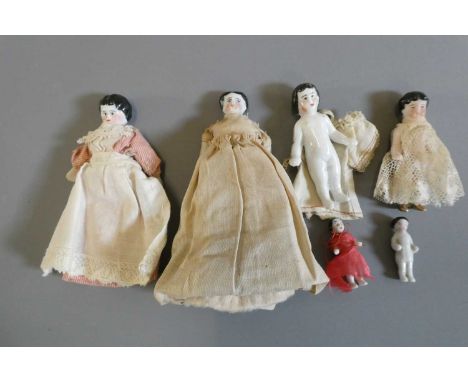 Six china doll's house dolls all with moulded and painted faces, the two larger examples with fabric bodies and bisque lower 