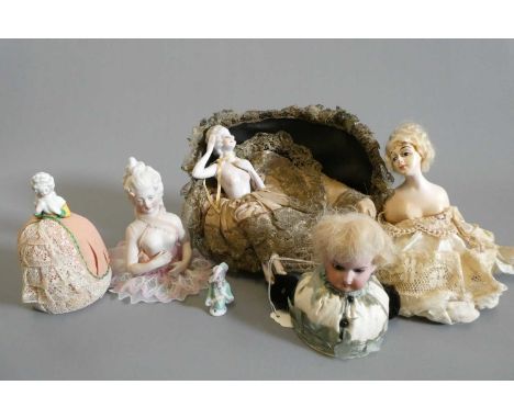Four pin cushion and two fashion dolls, one all china two part fashion doll on sofa, two china pin cushion dolls (one with cu