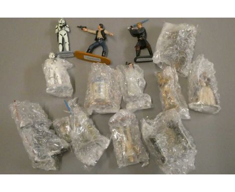 Fourteen loose Lucas Films solid cast Star Wars collectable figures, and thirteen Lucas Films Star Wars collectable space cra