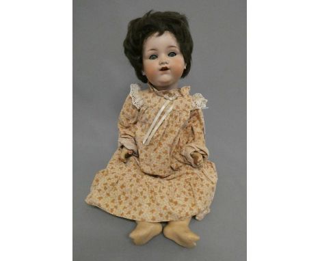 An Armand Marseille bisque socket head doll, with blue glass sleeping eyes, open mouth, teeth, bent limb composition jointed 