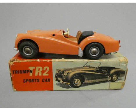 Victory Industries TR2 battery operated sports car in pink, body and chassis good but the windscreen is missing, box poor/fai