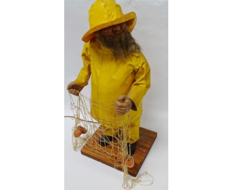 Automaton - A plug-in electrical figure of a bearded fisherman wearing yellow oilskins and Southwestern hat, when in motion t