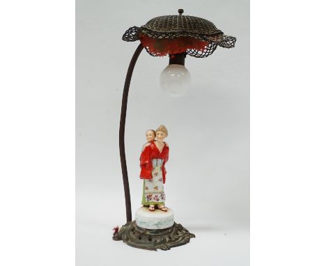 1920s Table Lamp - A Rococo gilt brass based electric lamp with a hand painted western woman dressed in a Japanese kimono, ho