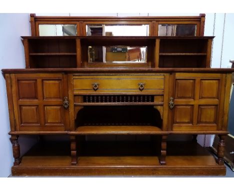 Arts and Crafts - James Shoolbred &amp; Co, Tottenham House, Tottenham Court Road, London, a walnut sideboard with central dr